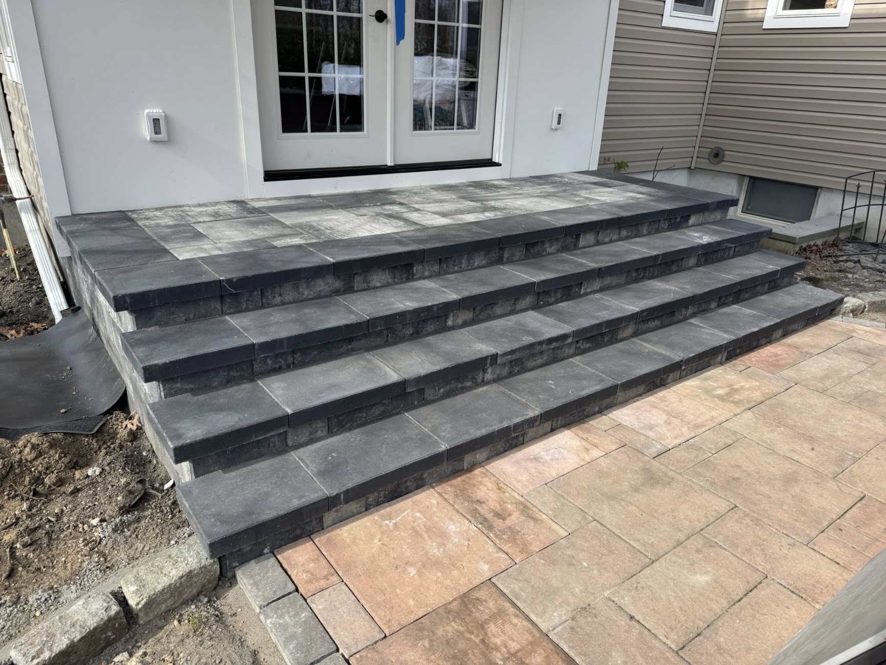 Paschette-installed charcoal bluestone stoop and steps leading to French doors in Suffolk County